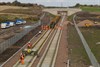 GB Railfreight 66706 Nene Valley, propels the track laying train at Shawfair, laying the Down track on November 8. Network Rail plans are clearly marked Up to Tweedbank and Down to Edinburgh.