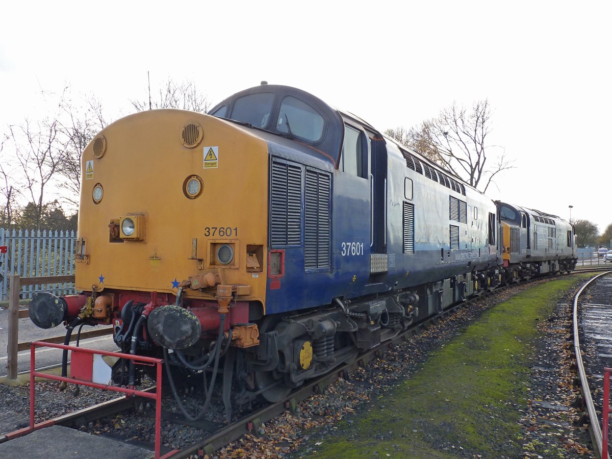 The oldest main line-certified Class 37 is currently Direct Rail Services 37601 Class 37 Fifty, which was delivered new to March depot on January 12 1961, as D6705. It stands at Crewe Gresty Bridge, couple to 37218.