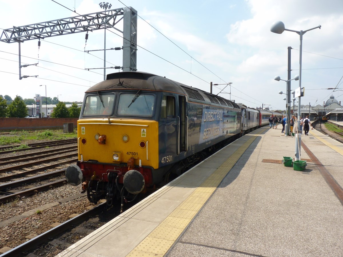 Direct Rail Services 47501 Craftsman stands at Norwich on July 12 2014, with the 1230 London Liverpool Street-Great Yarmouth. The '47' is now owned by Locomotive Services Ltd. RICHARD CLINNICK.