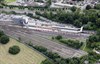 On September 4 2013, people enjoy a picnic in the field next to High Barnet station, where three trains of London Underground 1995 stock are present. The station is the terminus of the westerly of the two branches of the Northern Line.