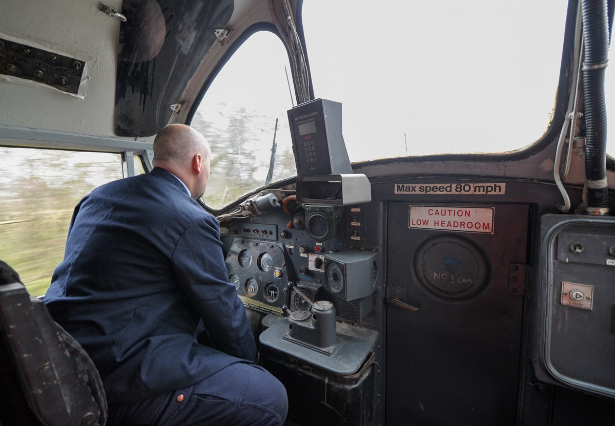 On board 37674 as it hauls the 1400 Redmire-Northallerton West, as driver Paul Warren sounds the horn on approach to a level crossing.