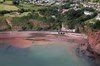 Having left Parson's Tunnel, a First Great Western High Speed Train crosses a small viaduct that carries the railway across Smuggler's Cove. The next station the HST will pass is Teignmouth. First Great Western train approaching Smugglers Cove