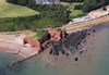 A First Great Western Class 143 bound for Paignton passes Langstone Rock, between Dawlish Warren and Dawlish. The landmark was once connected to the adjacent cliffs, but was severed during the construction of the sea wall railway. First Great Western train passes Langstone Rock