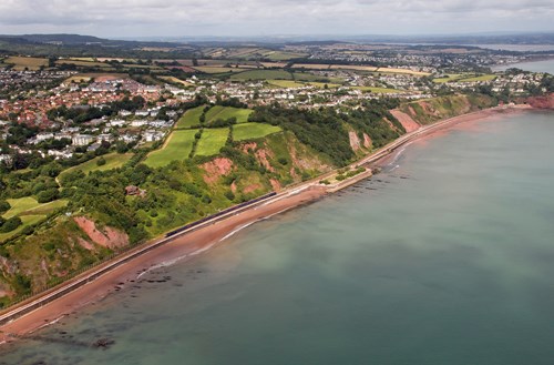 A First Great Western High Speed Train heads for Teignmouth, having passed Sprey Point. This section of the sea wall suffered from landslips. It was also this section that threatened the re-opening of the railway, because of rocks crashing onto the track after being loosened by the heavy rain. On the landward side of the railway remains a lime kiln that was used during the construction of the line here. First Great Western train passes Sprey Point