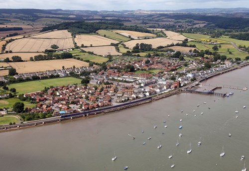 A First Great Western High Speed Train races west through Starcross. A pumping station from Brunel's atmospheric railway remains, standing next to the two-platform station used by FGW. First Great Western train races through Starcross