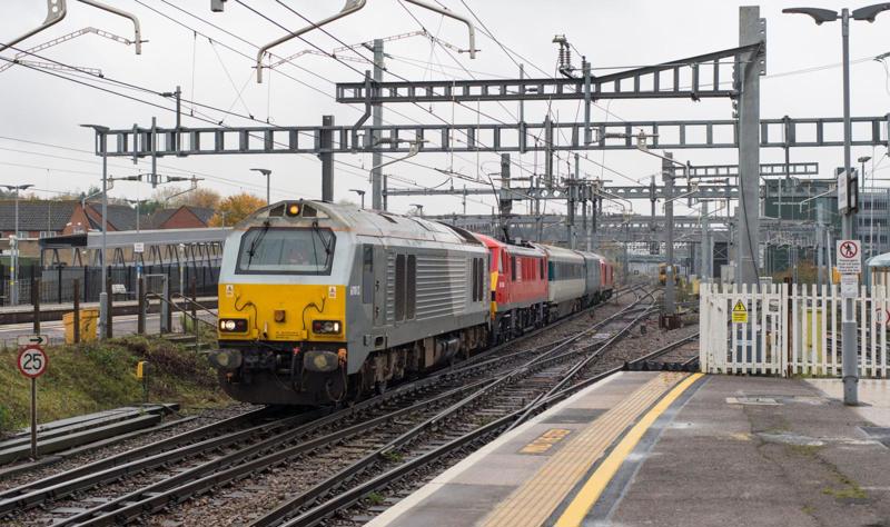 Was GWML electrification a successful project? On November 15 2019, an overhead line test train led by 67012 and 90028 (and with 67028 on the rear) runs through Didcot. KIM FULLBROOK.