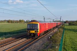 DB cargo operated Royal Mail class 325 postal trains passing the countryside at Brock on the west coast mainline in Lancashire. ALAMY