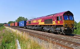 DB Cargo 66068, in original EWS livery, passes the Mortimer foot crossing (between Reading and Basingstoke) on July 31 with the 0903 Southampton Western Docks-Birch Coppice intermodal MARK PIKE.