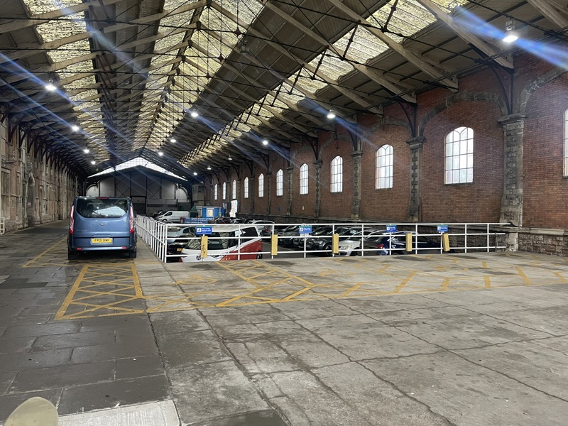 Cars parked inside the original Brunel-designed Bristol Temple Meads. BTQLLG.