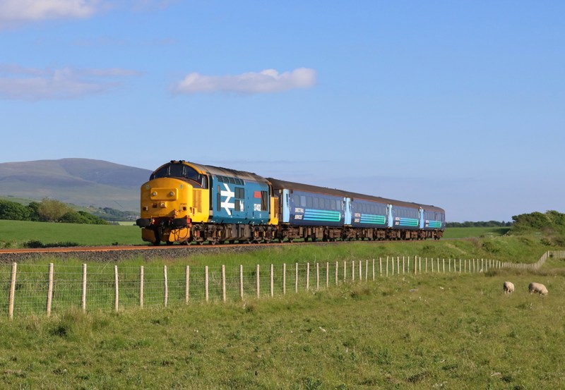 Northern's 1731 Barrow-Carlisle, hauled by DRS 37402, passes Black Combe Fell on June 2. TOM MCATEE.