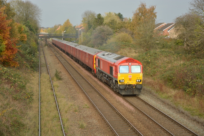 A DB Cargo Class 66 tows three Royal Mail '325' units through Shrewsbury en-route to Newport for scrapping