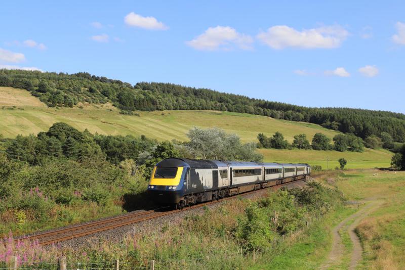 On July 28, because of industrial action, the 1552 Edinburgh-Inverness was worked by an Edinburgh crew that did not sign the route from Dunblane to Perth, so ran via Ladybank. 43137 leads 43037 past Woodmill Mains (near Lindores Loch) on the single-track line. PIP DUNN.