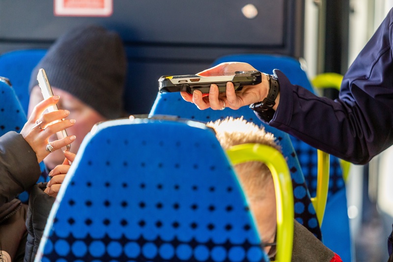 A ticket being checked by a conductor on a train