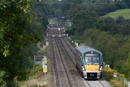 On August 3, five-car ICR No. 22038 is at milepost 1323⁄4 with a 1400 Dublin-Cork service, having passed Newtown and Ballyhay crossings, south of Charleville station in the distance. HASSARD STACPOOLE.