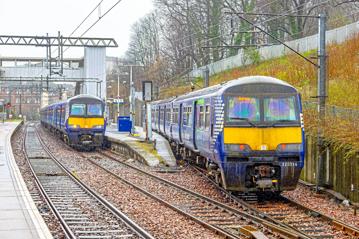 Under dreich Strathclyde skies, ScotRail 320314 arrives into Dalmuir Platform 5 with the 0926 from Motherwell while 320417 waits in Platform 4 on March 15. ALEX AYRE.