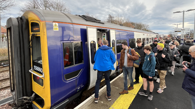 Passengers boarding a Northern Class 158 at Ashington on the Northumberland Line. NORTHERN.