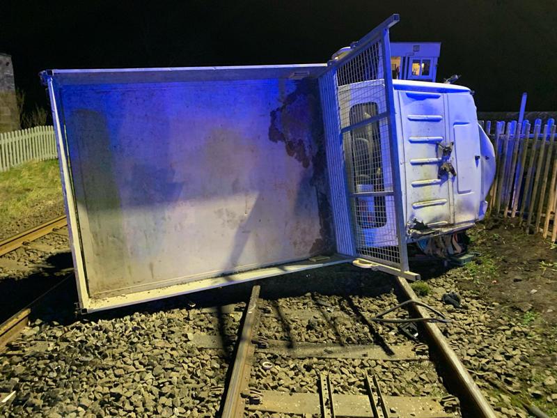 The dropside van on its side at Onibury level crossing. NETWORK RAIL.