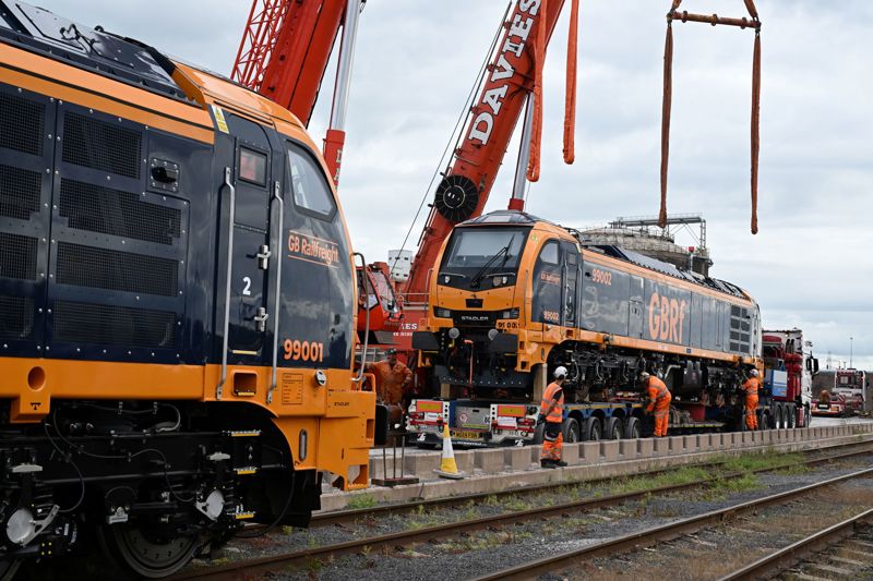 GBRf's 99002 is lowered onto rails at Bristol Port on June 10, 99001 is already on land. GB RAILFREIGHT.