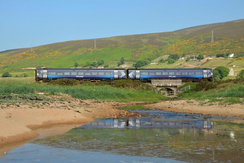 Discontinuous electrification on the Far North Line, as part of net zero plans, could involve hydrogen trains replacing the current diesel units. A ScotRail service from Inverness to Thurso crosses the Culgower Burn bridge near Helmsdale on July 3 2021. ALAMY.