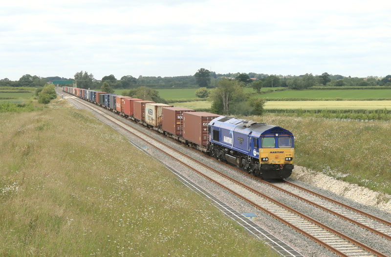 DB Cargo 66090 west of Calvert on East West Rail with 1104 Didcot-Northampton Gateway intermodal service, the first freight flow on the route. PHIL MARSH.