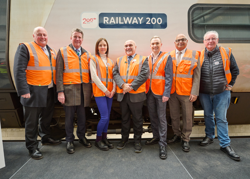 The Greatest Gathering Launch 5 –  (left to right) Andy Mellors, Managing Director at Avanti West Coast, John Smith OBE, Chief Executive Officer at GB Railfreight, Emma Roberts, Programme Manaer at Railway 200, Gian Luca Erbacci, Europe Region President at Alstom, James Dobson, Operations Delivery Manager at Avanti West Coast, Baggy Shanker, Labour MP for Derby South, and Pete Waterman, legendary music and rail enthusiast. ALSTOM.